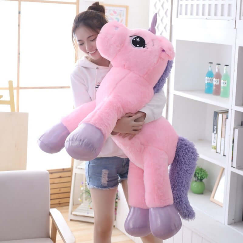 A child joyfully hugs a plush unicorn pillow soft toy, perfect for toddlers, babies, and children.