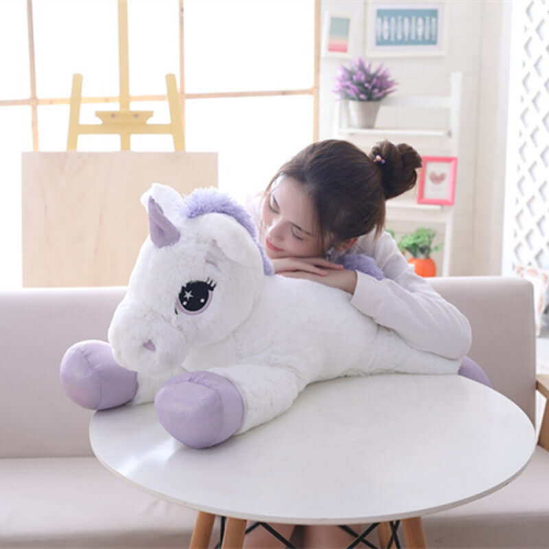 Toddler snuggling with a plush unicorn pillow soft toy, perfect for babies and children, made from cozy PP cotton.